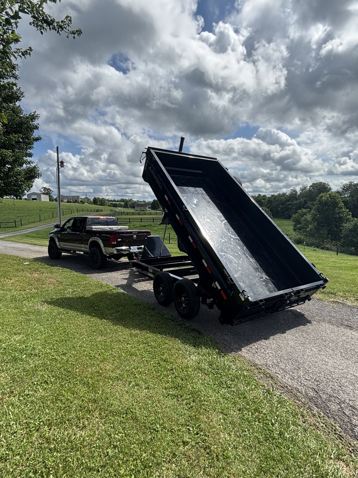 Black dump trailer with bed raised