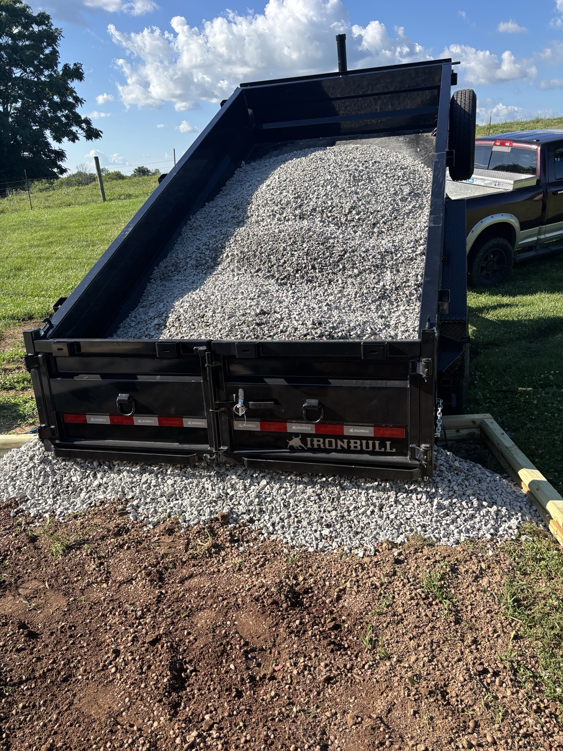 Dump trailer delivering gravel